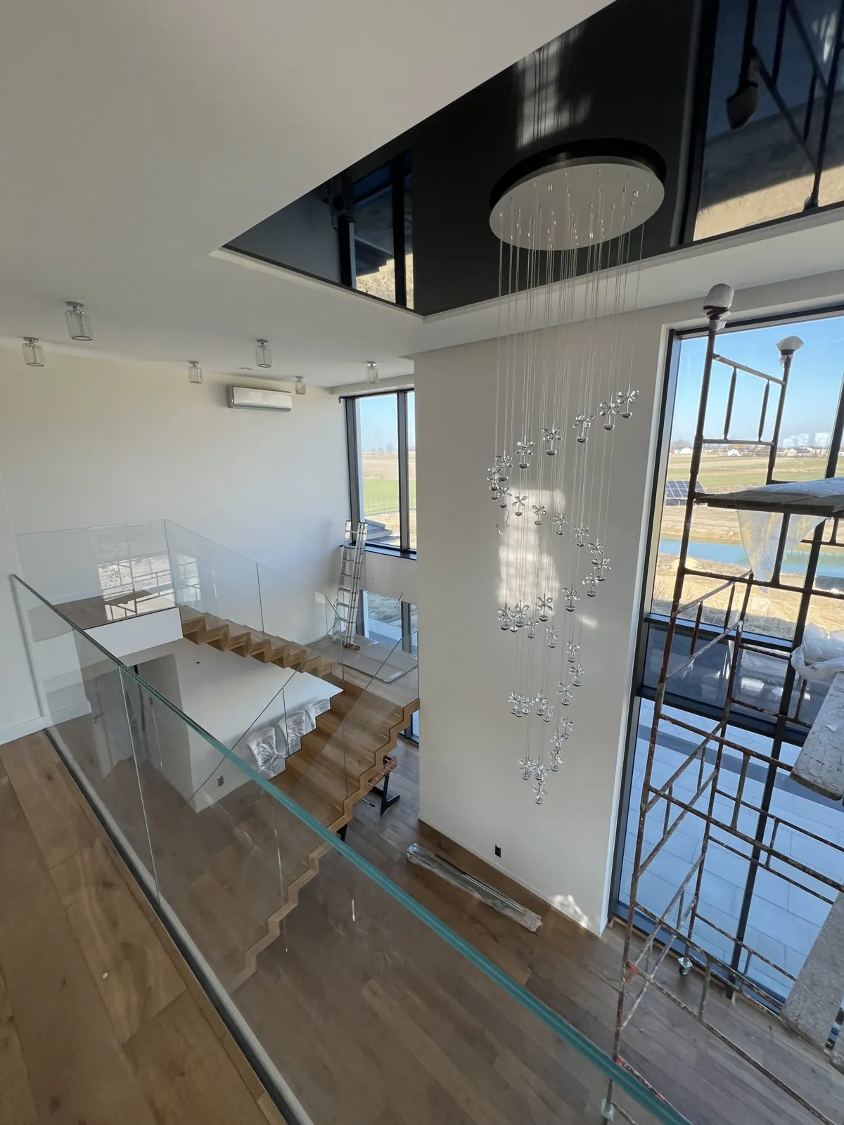 Antresola ze szklaną balustradą i czarnym sufitem